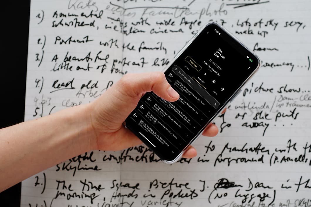 mockuuups-iphone-12-pro-mockup-held-over-a-sheet-of-paper