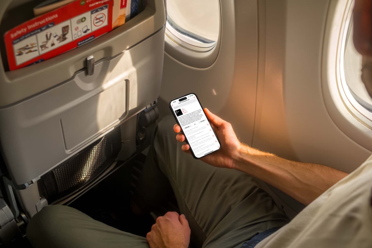mockuuups-iphone-14-pro-on-a-plane-mockup Large