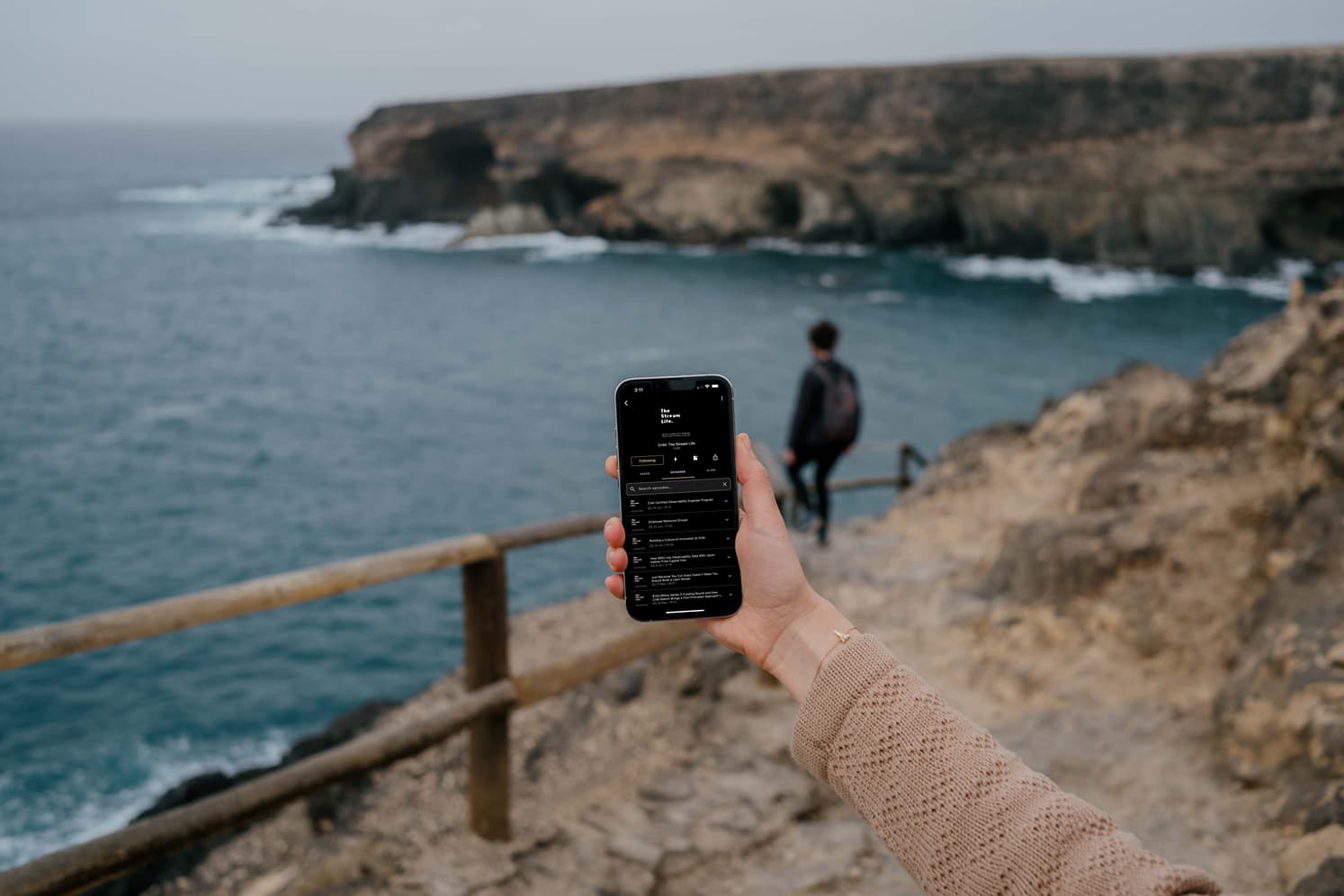 mockuuups-iphone-13-pro-mockup-held-by-a-user-at-a-coastline