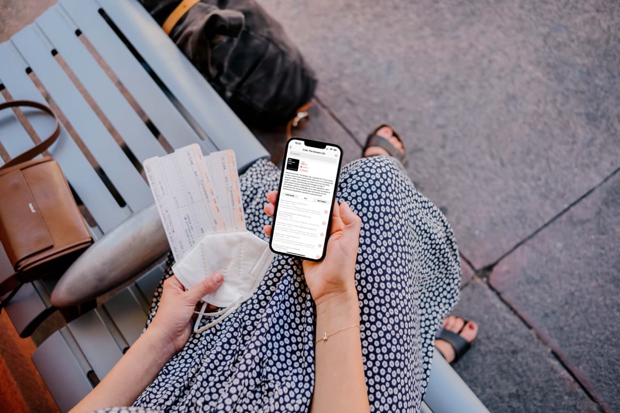 mockuuups-woman-holding-iphone-mockup-and-train-tickets Large