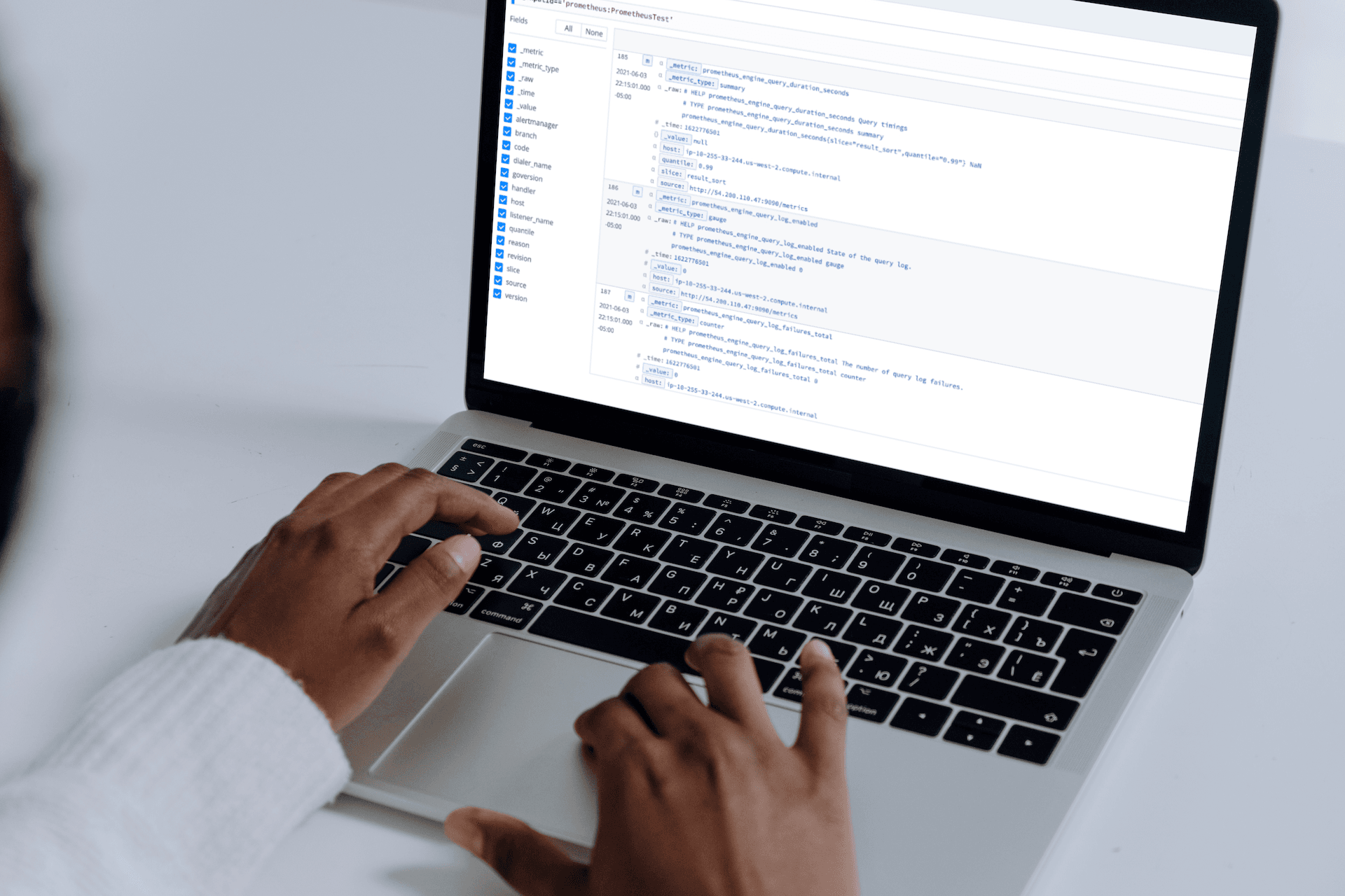 mockuuups-macbook-pro-mockup-on-a-white-table-used-by-woman